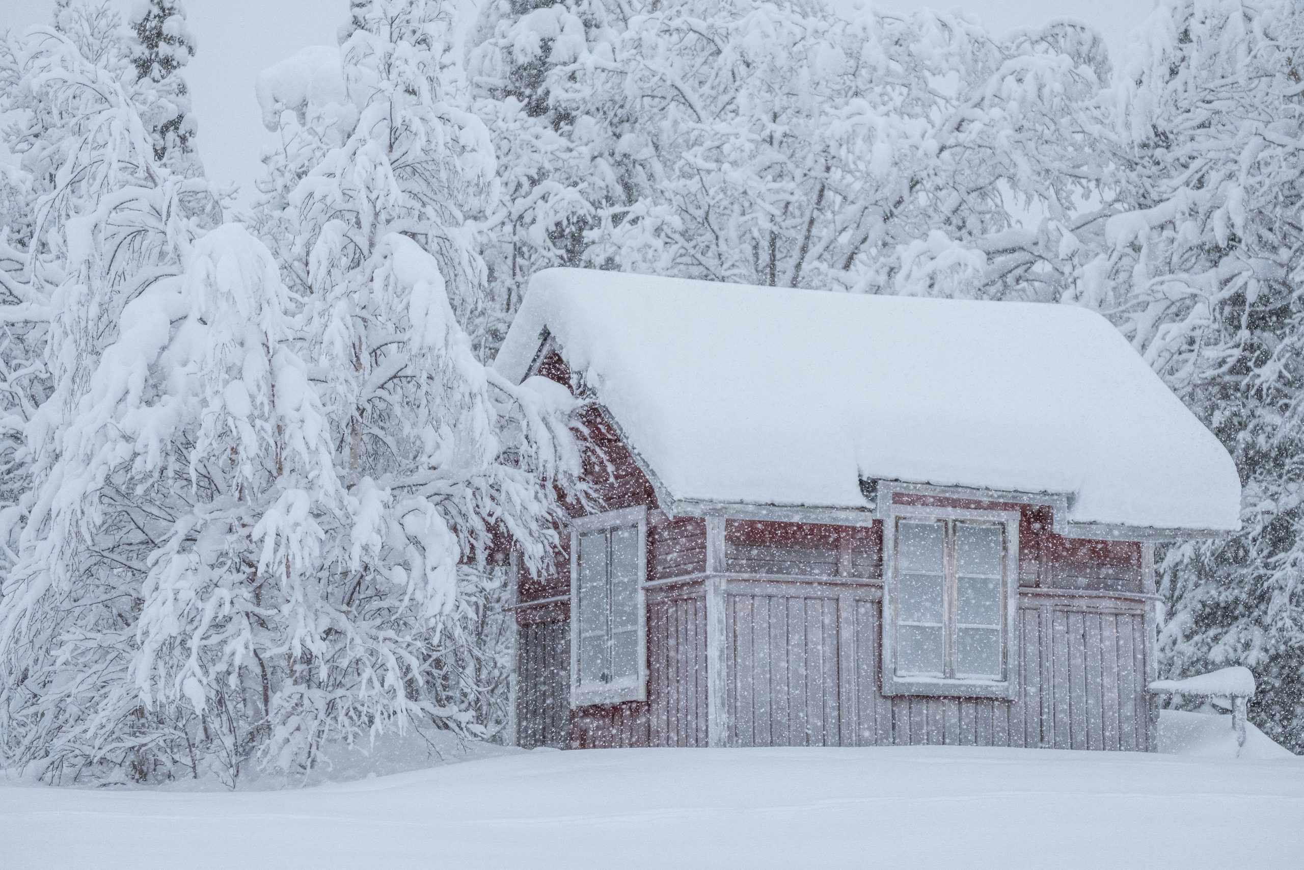 A snow-covered cottage with a freshly fallen path, ready for shoveling before winter sets in